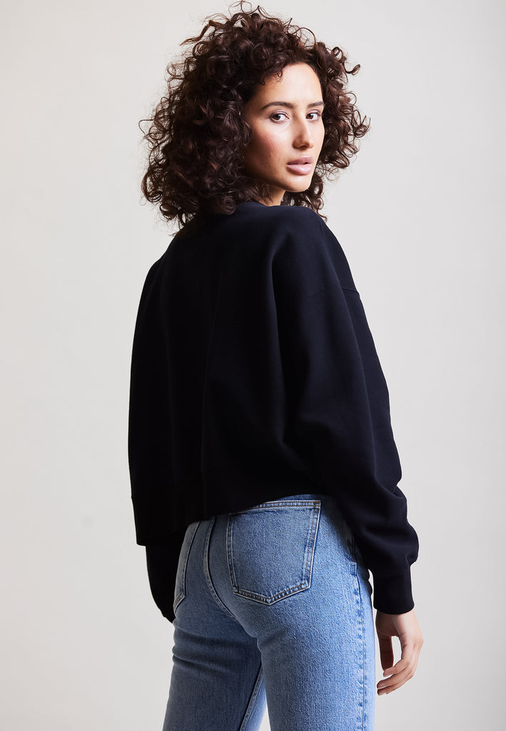 ["Black", " Model trägt Cropped Sweater in Schwarz Rückenansicht"]